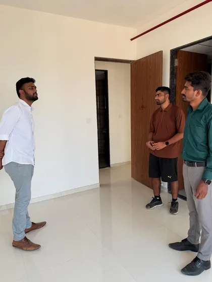A full view of the initial client meeting in an empty apartment, setting the stage for the transformation to come.