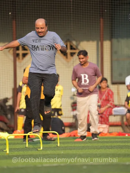 A father participates in agility drills alongside the kids. We believe parents are the biggest cheerleaders, and it's inspiring to see them lead by example on the field.