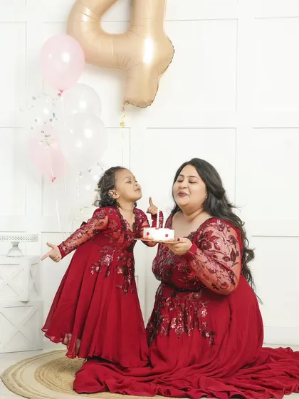 We love celebrating milestones! This mother-daughter birthday photoshoot was styled with matching red dresses and a cake to mark a special fourth birthday. Themed sessions like this are a wonderful way to create unique and memorable portraits.