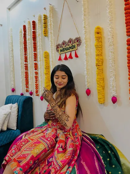 A quiet, happy moment from Shrutika's mehendi ceremony. The festive decor and her beautiful henna create a perfect picture.