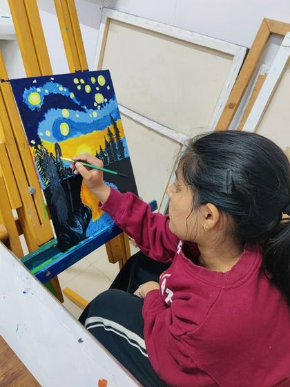 A young student recreates Van Gogh's "Starry Night," learning about impressionistic style and bold color application.