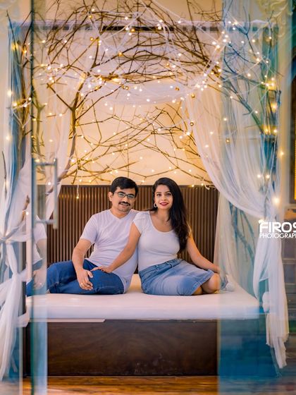 A relaxed and happy couple enjoying the cozy ambiance of our indoor bed set with its whimsical fairy lights.