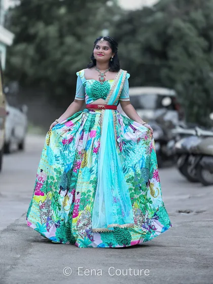 My flora and fauna lehenga is perfect for celebrating youthful grace. The vibrant, printed skirt is paired with a textured green blouse and a light blue net dupatta, creating a fresh and lively look for my teenage client Honisha.