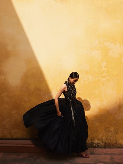 Another shot playing with the movement of the black dress against the yellow wall.