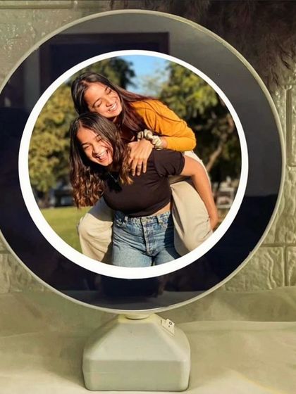 This is a magic mirror that looks like a regular mirror until you turn it on, when it lights up to reveal a hidden photo inside.