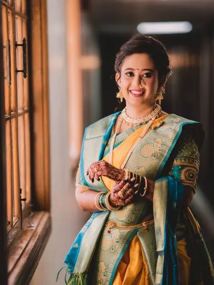 A happy and confident bride, ready for her big day. Her makeup is fresh and radiant, and her smile is the perfect finishing touch.