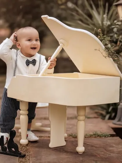 A curious little musician exploring the piano. I love capturing these moments of discovery and play during my themed photoshoots.