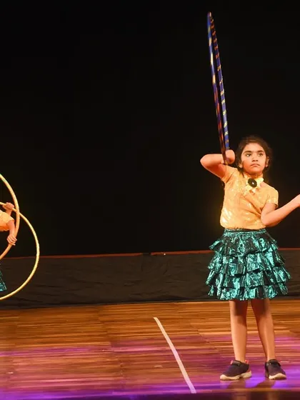 Two young dancers showcase their hoop skills with different poses. This highlights the individual creativity and confidence we encourage in our students.