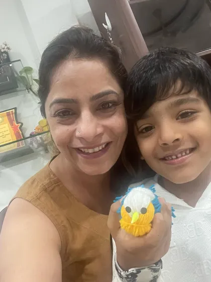 Look at this adorable little bird! A proud student shows off his creation from our craft workshop. These activities are great for developing fine motor skills.