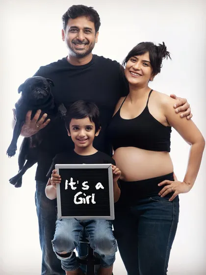 A joyful family portrait announcing "It's a Girl." Our studio sessions are perfect for creating clean, classic, and fun announcements for your growing family.