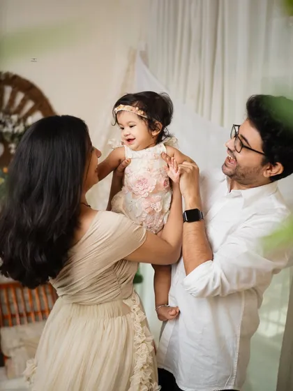 The family plays together, their focus entirely on their little girl. These are the candid, interactive moments that tell the real story of your family.