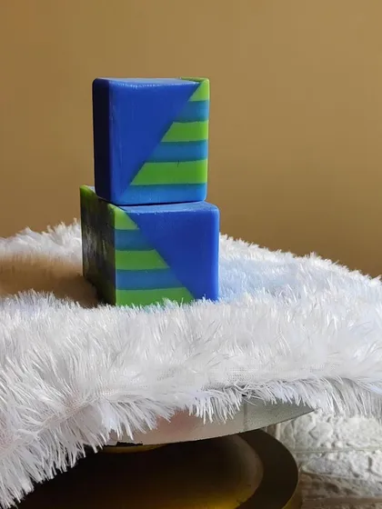 A modern, geometric-patterned soap in shades of blue and green.