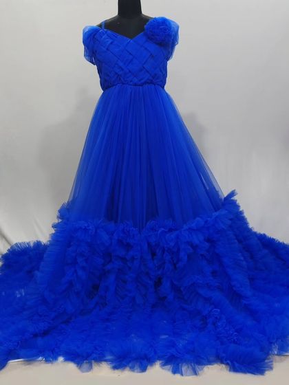 This royal blue gown is one of my most popular rentals. It features a textured bodice and a voluminous, ruffled train that creates incredible drama and movement in photos.