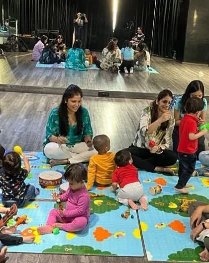 Instrument time is always a favorite. Children learn to share and play together, exploring different sounds with shakers, drums, and bells in a group setting.