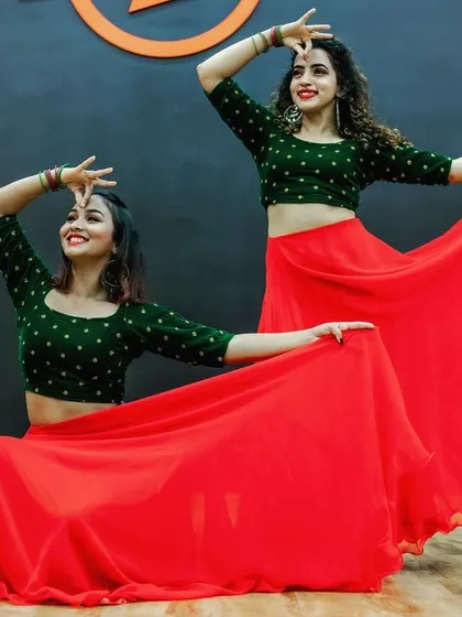 Posing during our 'Laal Ghaghra' shoot. This style of choreography, with its vibrant costumes and expressive moves, is a popular choice for bride and bridesmaid performances.