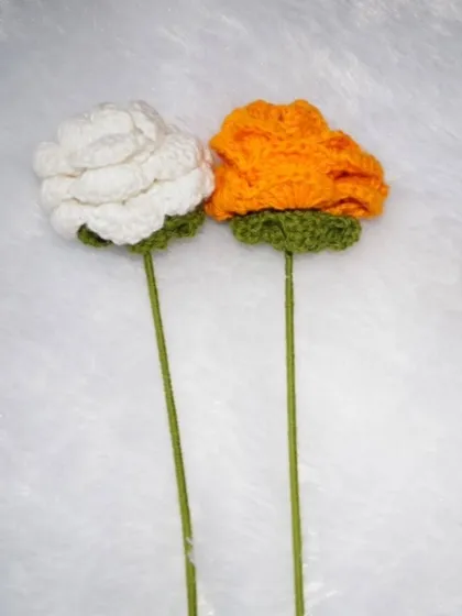 A clean shot of my white and orange crochet roses, showing their form and texture. These are a great sustainable alternative to real flowers.