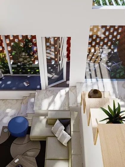 An aerial view of a double-height living space designed to feel expansive and intimate at the same time. This open-well atrium design is one of my key strategies for flooding homes with natural light and creating visual connections between floors.