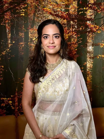 This look is the perfect checklist for bridesmaid makeup. We have neutral eyes, a glossy nude lip, a sheer radiant complexion, and beautiful wavy hair pinned up softly.