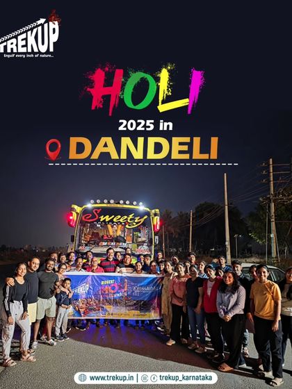 The start of our Holi 2025 trip to Dandeli, with the group posing in front of the bus at night.