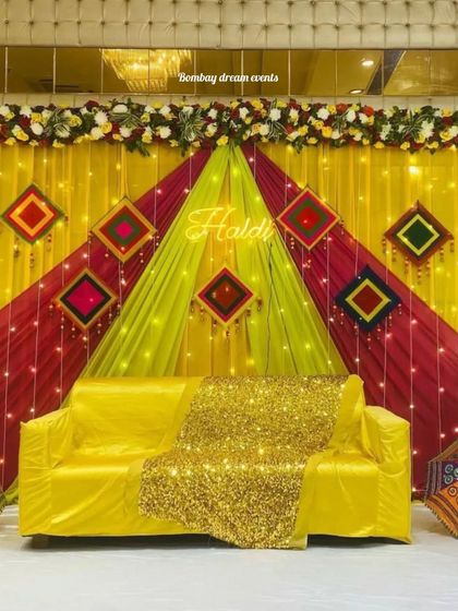 I love adding a touch of glam. This Haldi seating includes a gold sequin throw to make the bride-to-be shine.