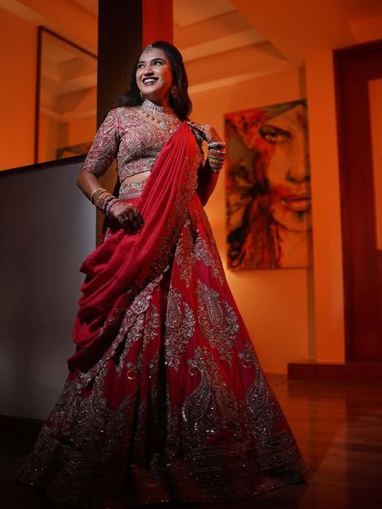 A happy and confident bride. Varsha is glowing in her red lehenga, her makeup enhancing her natural beauty.