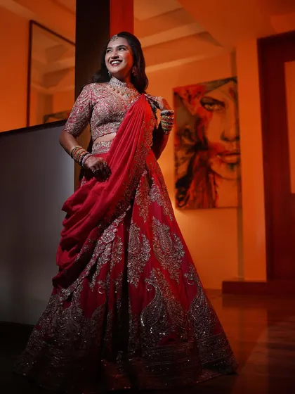 A happy and confident bride. Varsha is glowing in her red lehenga, her makeup enhancing her natural beauty.