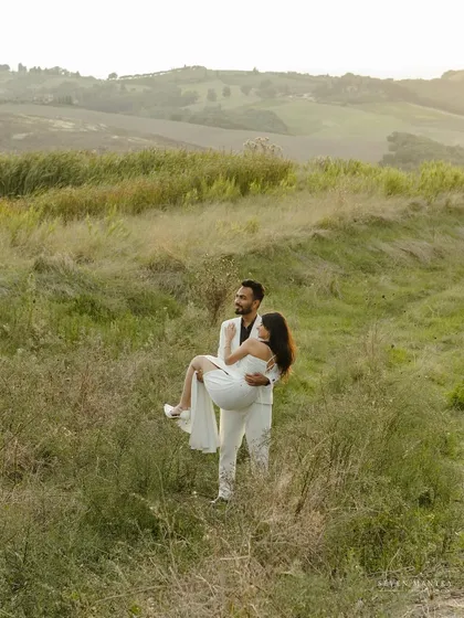 A classic romantic gesture in a beautiful, natural setting. This moment from a Tuscany pre-wedding shoot showcases the gentle and caring side of a couple's relationship.