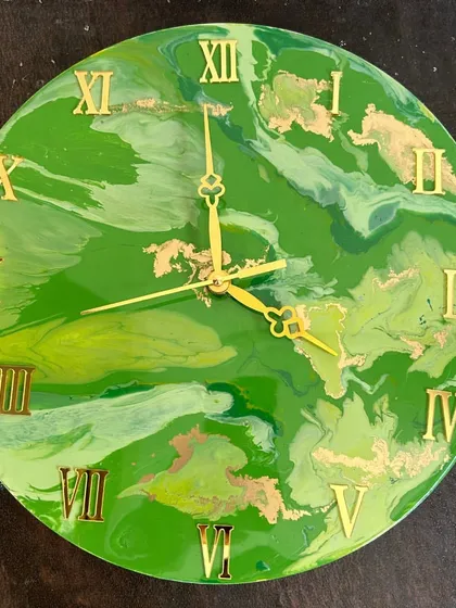 A bright green marble resin clock with gold accents, perfect for adding a pop of color to any room.