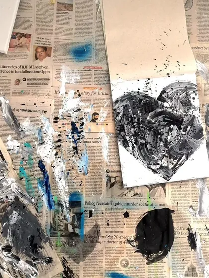 A behind-the-scenes look at my messy workspace while creating the black and white heart painting. The process is just as important as the final piece.