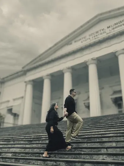 A classic pre-wedding pose on the steps of The Asiatic Society of Mumbai Library. The colonial architecture provides a grand and timeless setting for elegant couple portraits.
