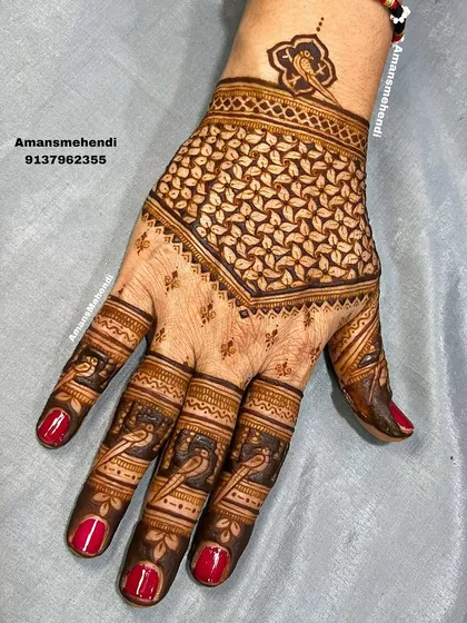 The same geometric leaf pattern, now with the fingers detailed with bird motifs, showing how a design can be customized and expanded.