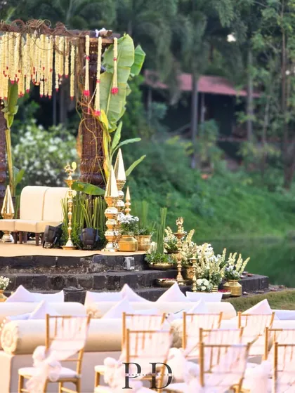 A side view of the lakeside South Indian mandap, showing the guest seating and the serene natural setting. We focus on creating a cohesive and immersive experience for everyone.