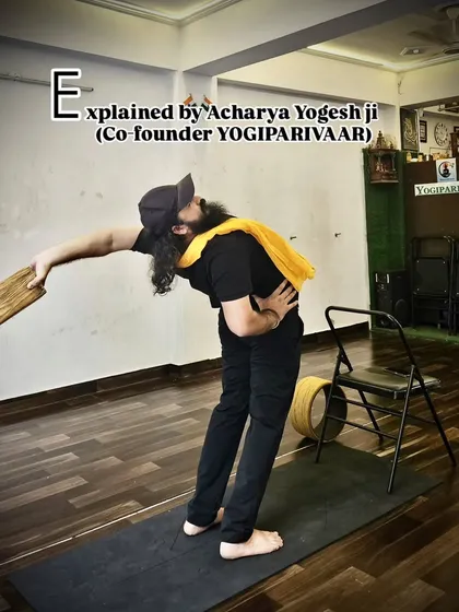 Acharya Yogesh Ji demonstrates how a simple yoga block can be used to refine a standing side bend, ensuring the stretch is effective and safe.