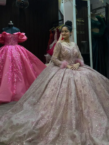 Another lovely seated shot of the dusty pink ball gown. This angle shows the delicate illusion neckline and the intricate beadwork on the bodice, details that make this gown so special.