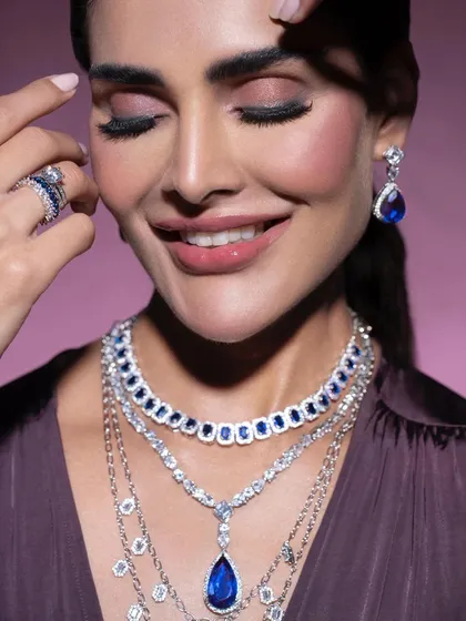 A happy, smiling shot that brings a sense of warmth and accessibility to luxury jewelry. It shows that high-end pieces can be styled in a way that feels personal and joyful.