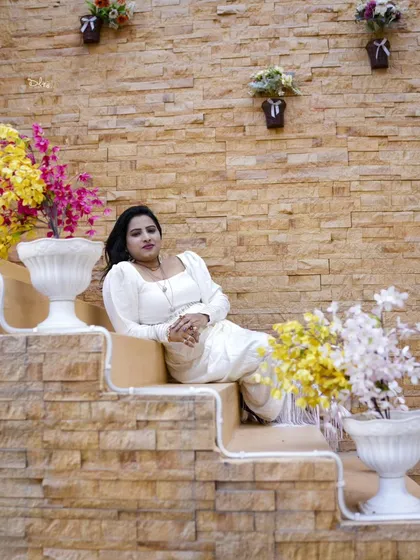 A relaxed portrait on a unique, multi-level staircase decorated with flowers. A great example of our creative indoor sets.