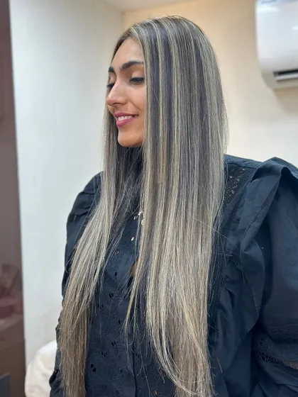 The side view of these ash highlights shows the beautiful, ribbon like effect on her long hair.