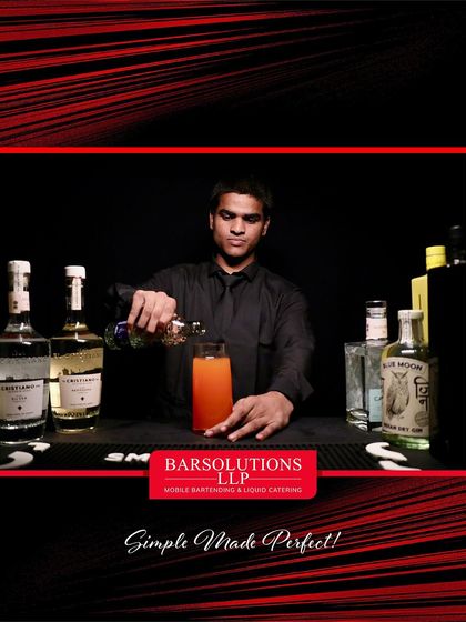 Crafting a vibrant orange cocktail at the Outhouse Jewellery event, where every drink matched the evening's sparkle.