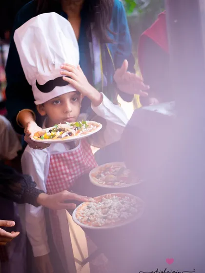 Event photography is about more than just posed pictures. It's about capturing the story of the day, like this little chef waiting to bake his own pizza at his birthday party. I focus on these candid, in-between moments that truly show a child's personality.