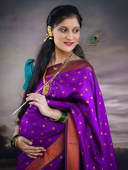 We can incorporate symbolic props like a peacock feather to add another layer of meaning and beauty to your traditional maternity portraits.