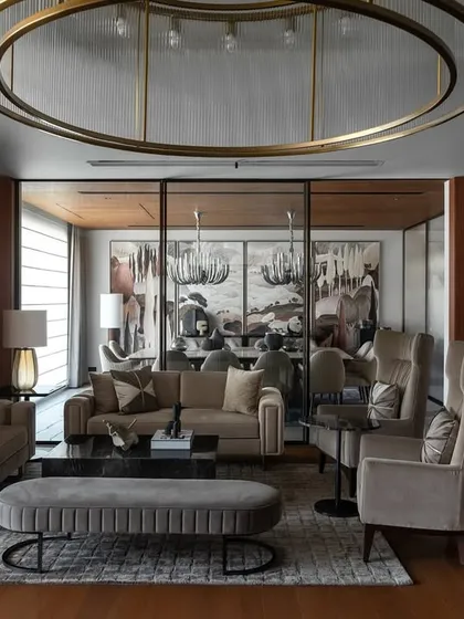 This living area in Residence 338 is designed for family connection. I used a mix of plush textures, a large circular light fixture, and curated art to create a sophisticated yet comfortable space for gathering.