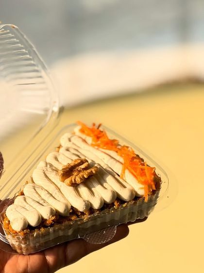 A slice of our healthy carrot cake, made without refined flour or sugar. It's a guilt-free way to enjoy a classic dessert.