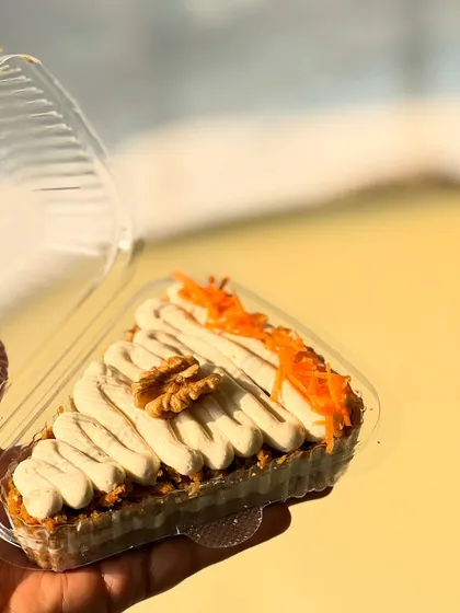 A slice of our healthy carrot cake, made without refined flour or sugar. It's a guilt-free way to enjoy a classic dessert.