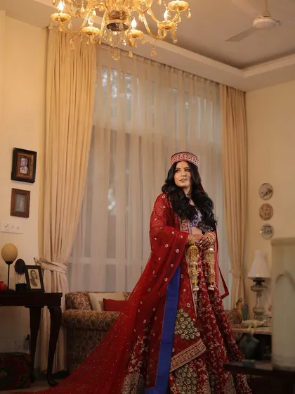 A beautiful shot showcasing the bride's full traditional attire. The makeup was kept classic and elegant to complement the rich colors and sentimental details of her outfit.