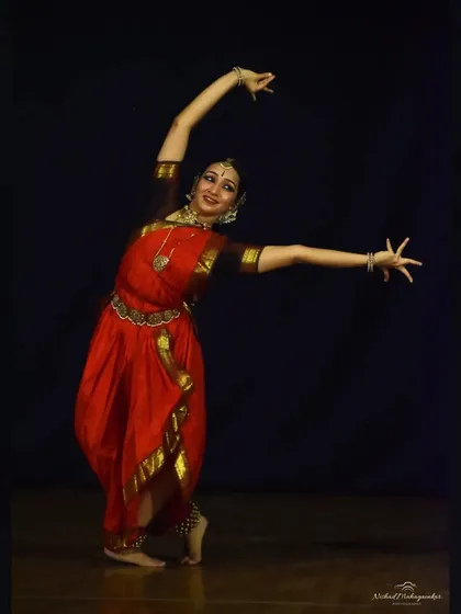 An expansive movement, reaching outwards, that conveys a sense of openness and offering. This photo captures the energy that fills the stage during a solo performance.
