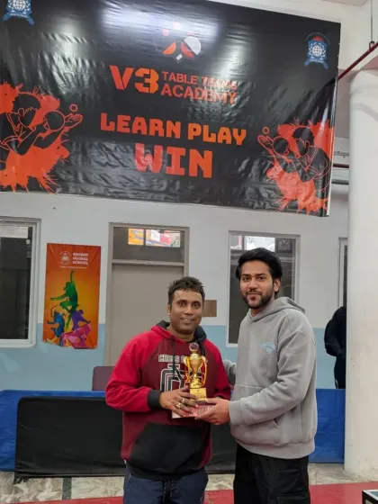 My coaching isn't just for kids. I'm presenting an award at our V3 Open Corporate Tournament, a fantastic event for adults to challenge themselves and connect with fellow players.