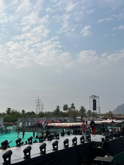 The view from the side of the stage at the Harris Jayraj concert. The depth of the stage and the extensive lighting setup along the front truss are visible, all supported by our infrastructure.