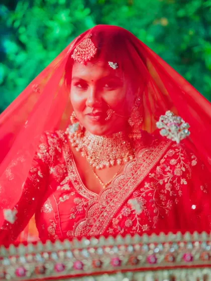 A classic bridal portrait with the veil framing her face, creating a timeless and elegant look.