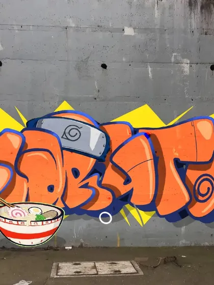 The final Naruto graffiti mural. I combined my graffiti lettering with the character peeking out, ready for a bowl of ramen.