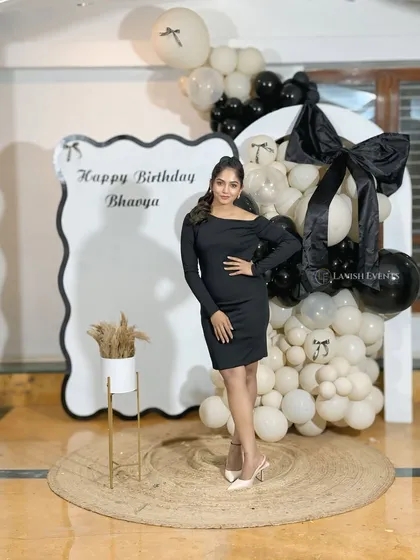 The birthday girl looking stunning against her monochrome bow-themed backdrop.